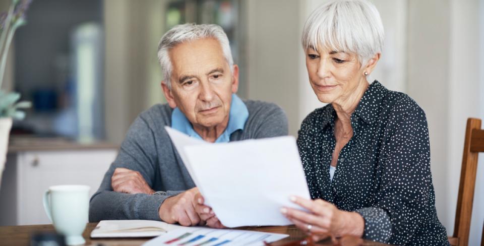 Two people reading a document