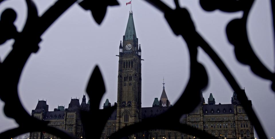 Photo of Parliament Hill through an iron fence